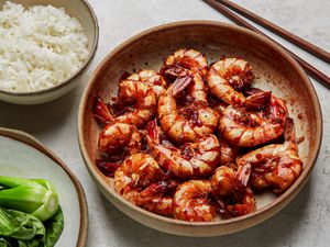 Overhead view of braised shrimp with a side of rice and bok choy