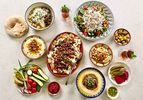 Overhead view of tablescape of multiple hummus plates