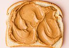 Slice of bread with peanut butter spread evenly