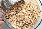 Overhead view of dumping oats into a bowl