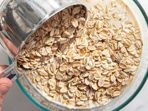 Overhead view of dumping oats into a bowl