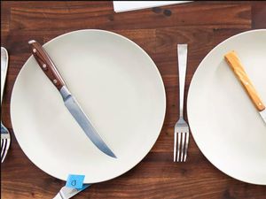 a closeup image of the messermeister knife on a plate with another knife and plate next to it