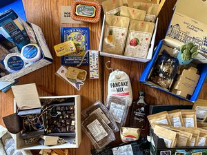 a variety of gift baskets contents on a wooden countertop