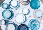 An overhead view of a table covered in outdoor dinnerware sets