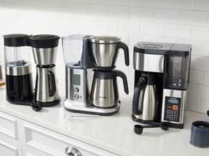 three coffee makers on a kitchen countertop
