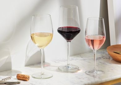 Three wine glasses filled with red, white, and rosé wine