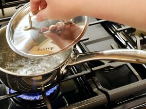 Water being boiled in a small saucepan.