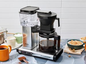 The Technivorm Moccamaster KBGV Select 10-Cup Coffee Maker on a kitchen counter with cereal and coffee