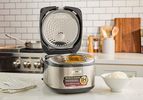 The Zojirushi rice cooker with its lid open.