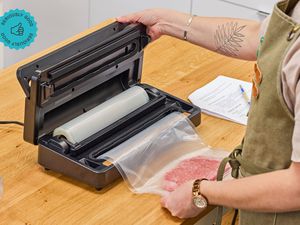 A person using an Anova vacuum sealer