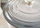 a closeup look at the lid of a grey le creuset dutch oven